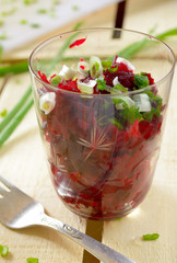 Fresh beetroot salad with bunch-onion in glasses