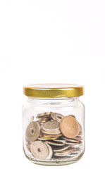 Japanese Yen coins in a mason jar over white background