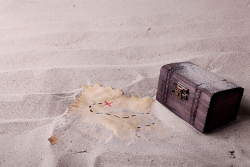 An old chest and a treasure map found in the sand