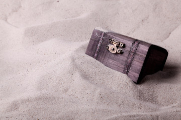 Treasure chest buried in the sand