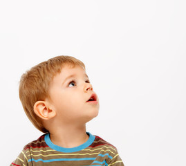 Boy in winter clothes looking up