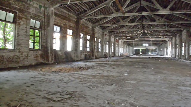 rotating of an empty industrial loft in an architectural background with bare cement walls, floors and pillars