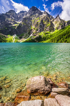 Fototapeta Pond in the middle of the mountains at dawn