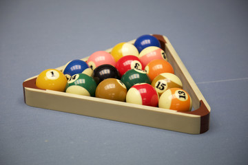 Billiard balls arranged in a triangle