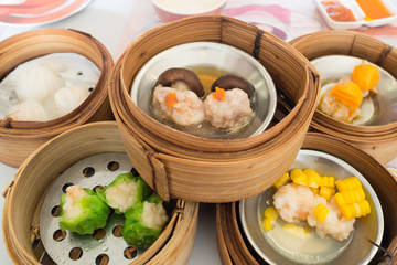 Yumcha, various chinese steamed dumpling in bamboo steamer in chinese restaurant. Dimsum in the steam basket, Chinese food