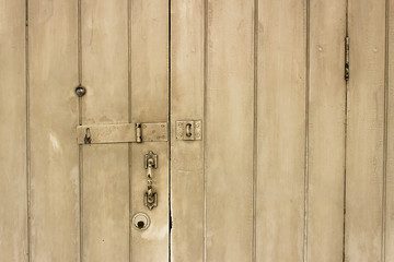 Obraz premium old wooden door with lock, handle, and eye hole.