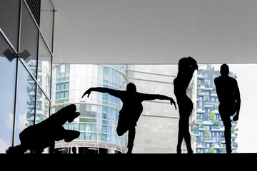 Beautiful dancers silhouettes performing in the city