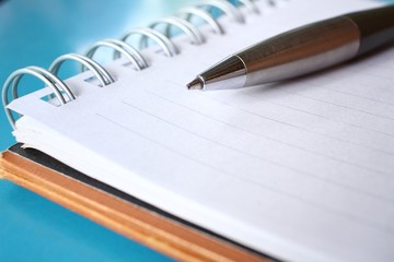 Blank notepad with pen on office table