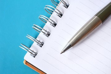 Blank notepad with pen on office table