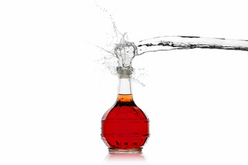 Wine. Bottle of red wine with water splash on white background