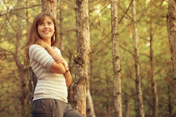 portrait of a beautiful girl in the coniferous forest