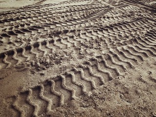 Wheel tracks on the soil.