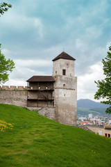 Fototapeta na wymiar The part of castle's wall with turret clock in Trencin, Slovakia