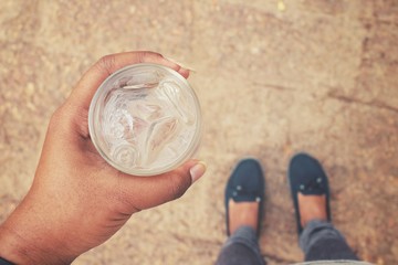 Selfie of drink water on hand with shoes