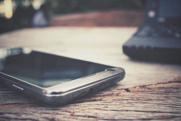 Notebook computer with smart phone on office table