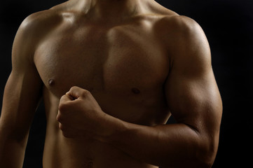 portrai of a man with biceps with black background