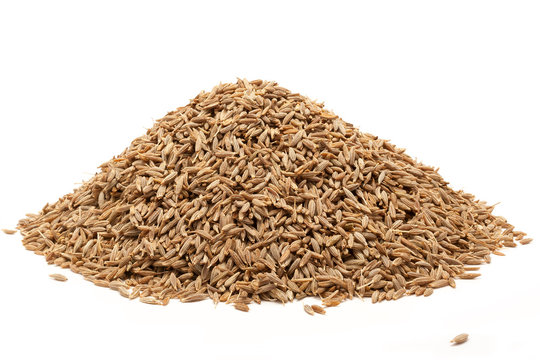 Pile of Organic Cumin seed  (Cuminum cyminum) isolated on white background