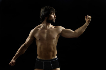 Fototapeta na wymiar portrait of a man with biceps with black background