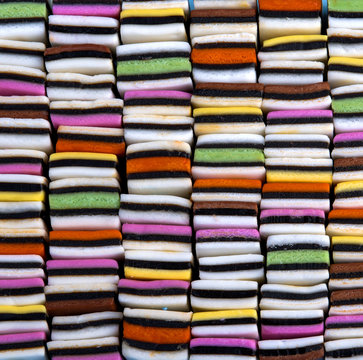 candy variety with colourful liquorice sweets neatly organized in a square, stacked pattern,