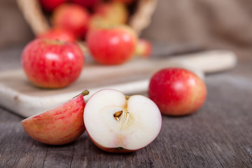 Naklejka na ściany i meble Autumn crops: red apples on a dark wooden table