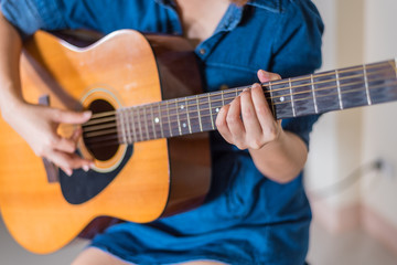 Fototapeta na wymiar girl playing acoustic guitar isolate on white