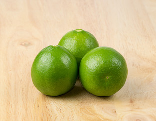 Fresh limes on wood background