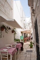 Fototapeta na wymiar Table set in the alley of Cisternino (Apulia)