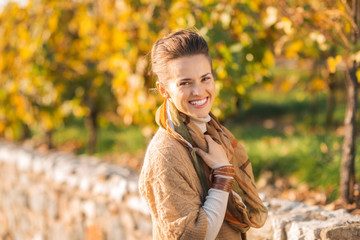 Portrait of happy elegant brunette woman in autumn outdoors