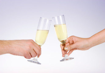 Two people toasting with wine glasses