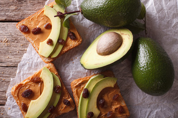 Beautiful sandwiches with avocado, peanut butter closeup. Horizontal top view
