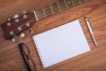 guitar notebook, pencil and eyeglasses