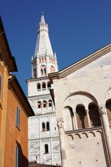 Detail of Dom San Geminiano, Torre Ghirlandina Cathedral under blue sky in Modena, Italy