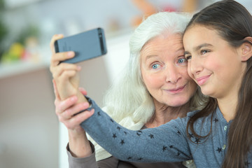 Little girl taking a selfie with her grandma