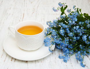 Cup of teand forget me not flowers