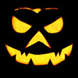 spooky halloween pumpkin jack o lantern shiny inside on black