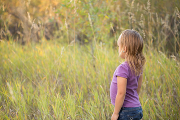 Little girl posing outdoors.