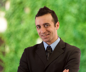 Young man in formal outfit looking with smile in camera