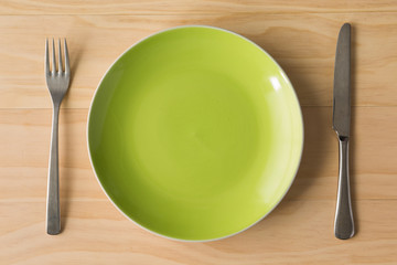 green plate with fork and knife