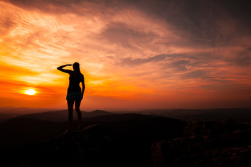 Silhouette of woman watching sunset