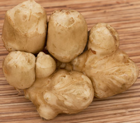 Jerusalem artichokes on a wooden background