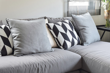 Black and white parallelogram pattern pillows on gray l shape co