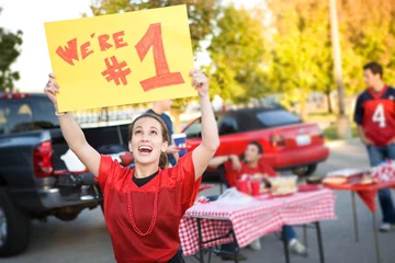 Fotobehang Tailgating: Woman Holds Up Number One Sign For Team © seanlockephotography
