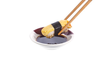 Chopsticks with sushi isolated on a white background
