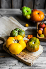 Colorful heirloom tomatoes on rustic wooden background