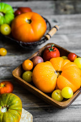 Colorful heirloom tomatoes on rustic wooden background