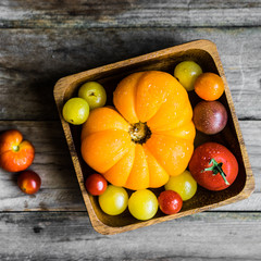 Colorful heirloom tomatoes on rustic wooden background
