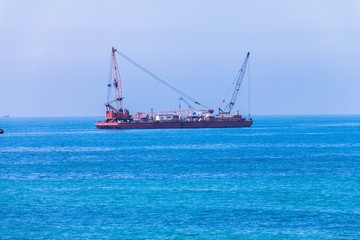 Port auxiliary tug ship equipped with cranes, hoists and winches
