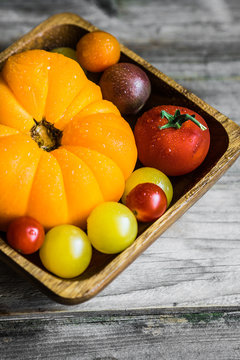 Colorful heirloom tomatoes on rustic wooden background