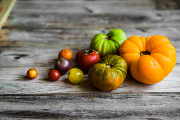 Colorful heirloom tomatoes on rustic wooden background