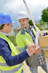Two site surveyors on a job